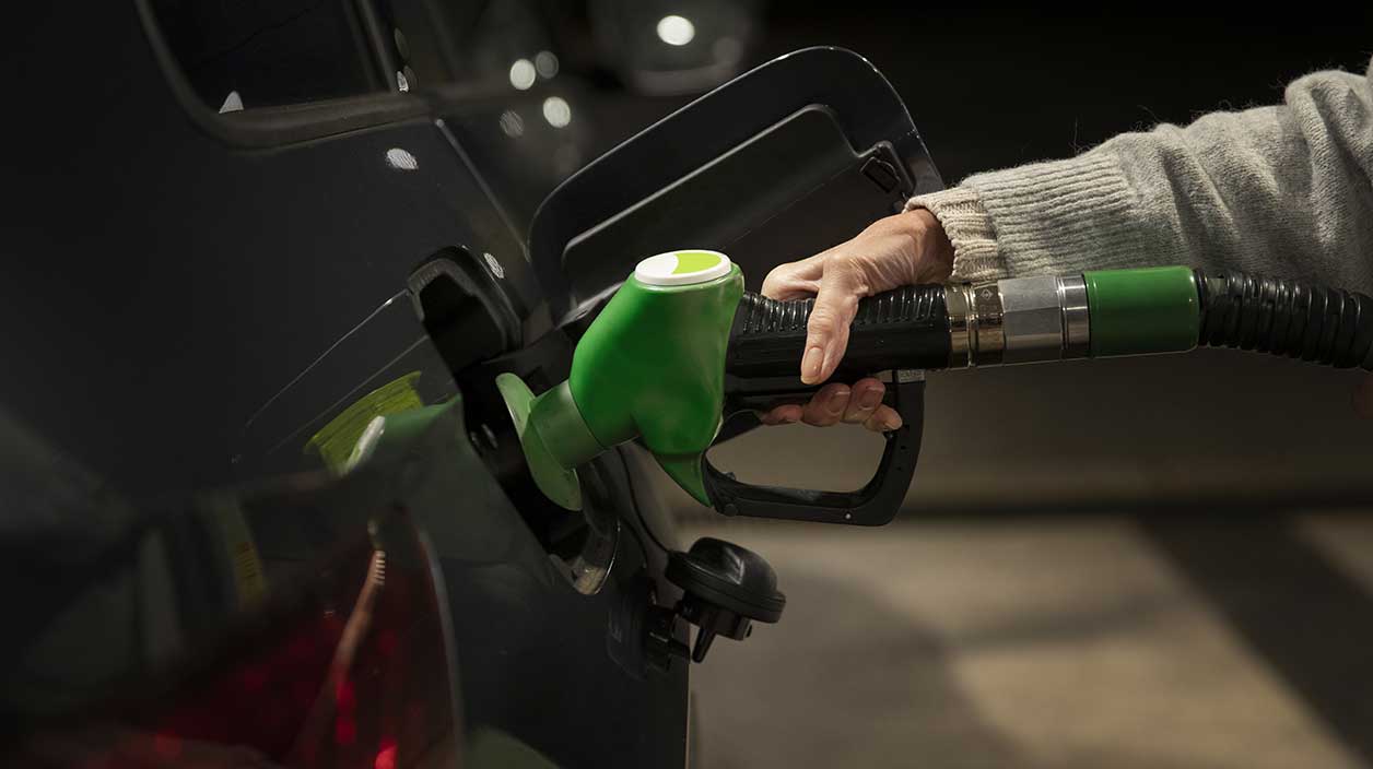 quelqu'n qui replit sa voiture avec de l'essence a la pompe